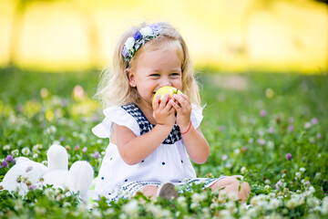 young beautiful baby girl eat apple