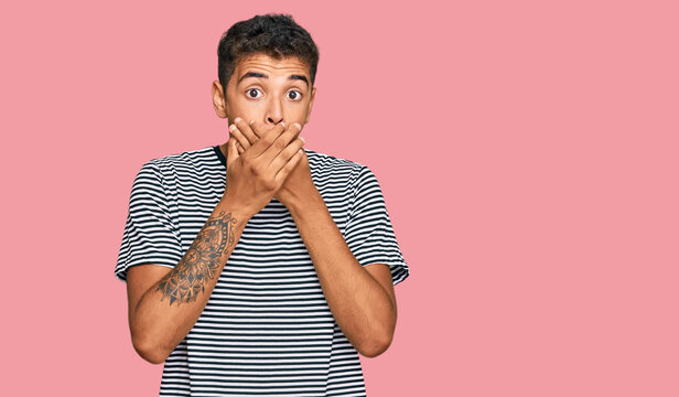 Young handsome african american man wearing casual clothes shocked covering mouth with hands for mistake. secret concept.