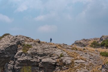 Hispanic hiker on top of mount Tlaloc under a cloudy sky in Mexico