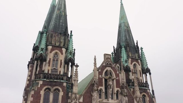 Aerial view of historical center of Church of St. Olga and Elizabeth old gothic temple in town Lviv, Ukraine. Flying by drone over dome. 4K UHD footage of landmarks, architecture of european Lvov city
