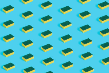 Fototapeta na wymiar Pattern made of kitchen sponges on pastel blue background