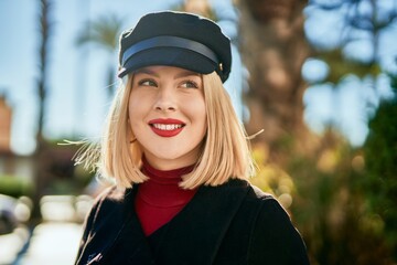 Young blonde woman smiling happy standing at the park.