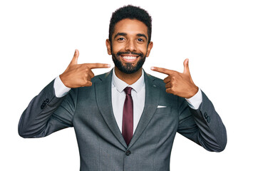 Young african american man wearing business clothes smiling cheerful showing and pointing with fingers teeth and mouth. dental health concept.
