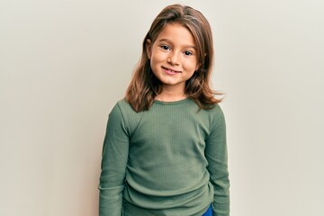 Little beautiful girl wearing casual clothes looking positive and happy standing and smiling with a...