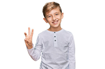 Little caucasian boy kid wearing casual clothes showing and pointing up with fingers number three while smiling confident and happy.