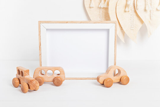 Eco fiendly child wooden toys and mockup frame in baby room interior