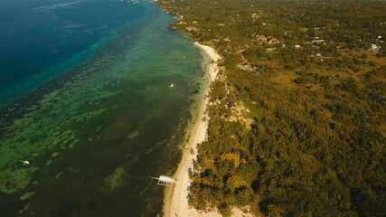 Aerial view tropica Alona beach on the island Bohol, resort, hotels, Philippines. Beautiful tropical island with sand beach, palm trees. Tropical landscape. Seascape: Ocean, sky, sea. Travel concept