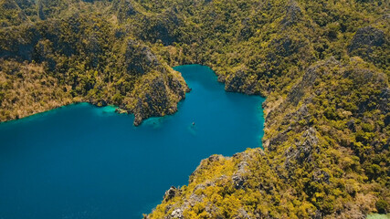 Aerial view: Mountain Barracuda lake, on tropical island with blue water. Lake in the mountains covered with tropical forest on the island Coron, Palawan, Philippines. Travel concept
