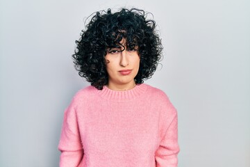 Young middle east woman wearing casual clothes skeptic and nervous, frowning upset because of...