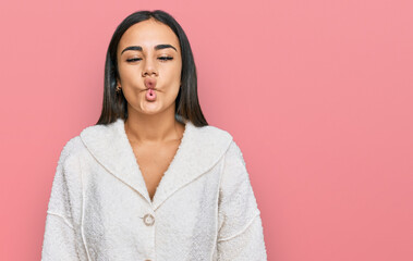 Obraz premium Young brunette woman wearing casual clothes making fish face with lips, crazy and comical gesture. funny expression.