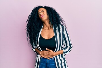 Middle age african american woman wearing casual clothes with hand on stomach because nausea,...
