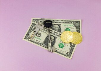 Bitcoin coins, house keys on a pink background. Selective focus. Concept for selling, renting, buying a house, investment.