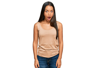 Beautiful hispanic woman wearing casual clothes afraid and shocked with surprise expression, fear and excited face.