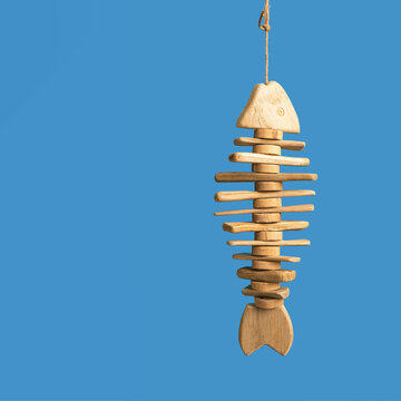 Fish On Hook Concept, Toy Fish Handmade From Old Pieces Of Wood Hanging. Sea Lifestyle Decorations.