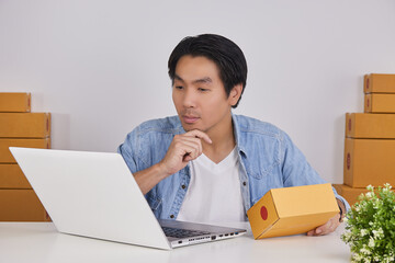 Online Merchant or Casual Businessman in Online Store Hold Parcel or Package and Serious Thinking About Shipping Cost