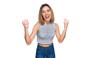 Young blonde girl wearing casual style with sleeveless shirt screaming proud, celebrating victory...