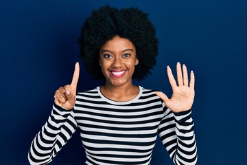 Young african american woman wearing casual clothes showing and pointing up with fingers number six while smiling confident and happy.