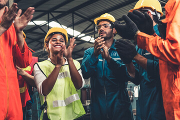 Skillful worker celebrate success in the factory . Industrial people and manufacturing labor concept .