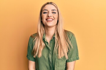 Young caucasian woman wearing casual clothes looking positive and happy standing and smiling with a confident smile showing teeth