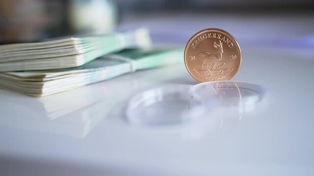High-quality footage of the Official currency of Poland and South African Krugerrand Coin in a vertical position. Sets of zlotych and Krugerrand. Narodowy Bank Polski. Bank Of Poland.