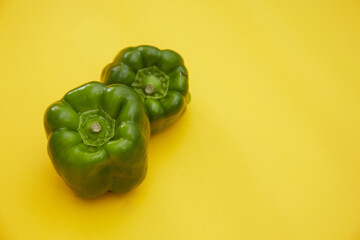 Top view of green chili pepper isolated on yellow background 