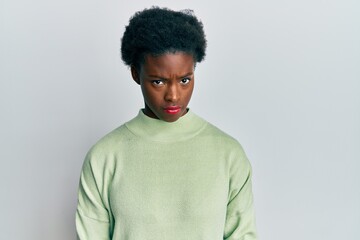 Young african american girl wearing casual clothes skeptic and nervous, frowning upset because of problem. negative person.