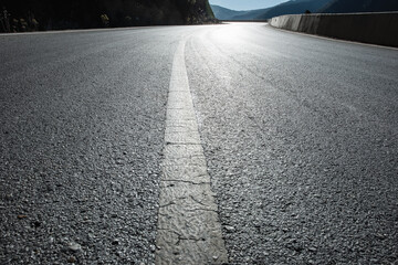 An open road under a snowy mountain