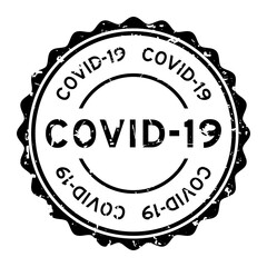 Grunge Covid-19 word round rubber seal stamp on white background