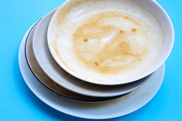 Dirty dishes on blue background.