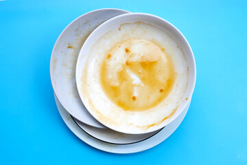 Dirty dishes on blue background.