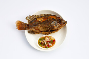Fried fish in white plate on white background.