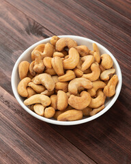 Cashew nuts in white bowl on the table, Healthy snack, Vegetarian food.