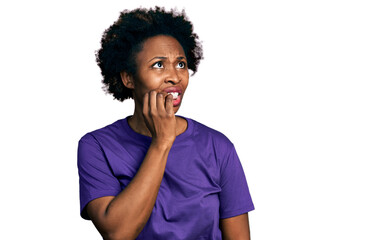 African american woman with afro hair wearing casual purple t shirt looking stressed and nervous...