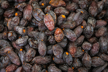 Close-up of purple raisins on a showcase in a supermarket, top view. Dried grapes