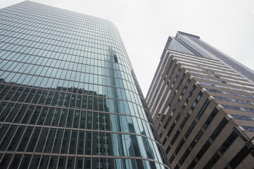 Fototapeta premium Glass Skyscraper Towers reflecting Blue Sky on Overcast Spring Day