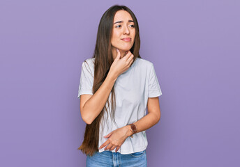 Young hispanic girl wearing casual white t shirt touching painful neck, sore throat for flu, clod and infection