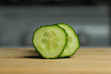 fresh green cucumber slices on a cutting board