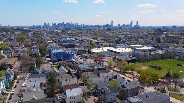 Somerville city center aerial view on Somerville Avenue with Boston skyline at the background in spring, city of Somerville, Massachusetts MA, USA. 