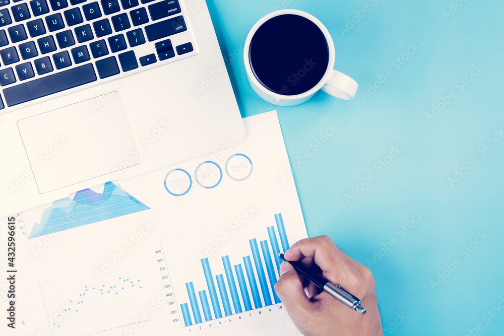 Aufkleber hand of businessman looking documents report statistic financial with graph and chart and laptop com