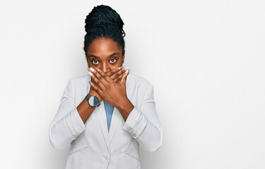 Young african american woman wearing business clothes shocked covering mouth with hands for mistake. secret concept.