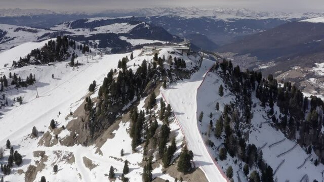 Aerial view of  People Skiing and snowboarding on hill, Ski Resort.
Drone flies over Skiers Skiing down the hill, Alp mountains, Dolmites Italy
