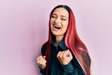 Young caucasian woman wearing casual clothes celebrating surprised and amazed for success with arms raised and eyes closed