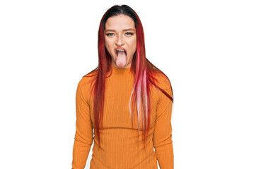 Young caucasian woman wearing casual clothes sticking tongue out happy with funny expression. emotion concept. © Krakenimages.com
