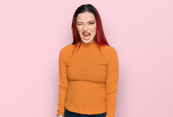 Young caucasian woman wearing casual clothes winking looking at the camera with sexy expression,...