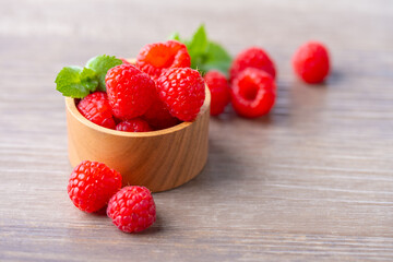 Fresh raspberries on wooden board.
