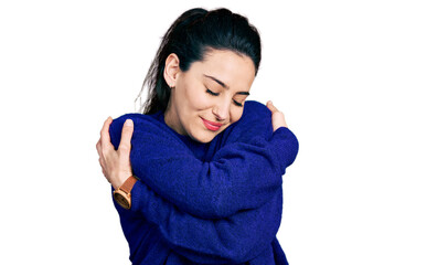 Young hispanic woman wearing casual clothes hugging oneself happy and positive, smiling confident. self love and self care