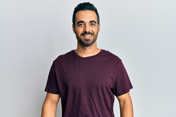 Young hispanic man wearing casual clothes with a happy and cool smile on face. lucky person.