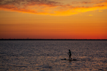 silhouette of a person with paddle board