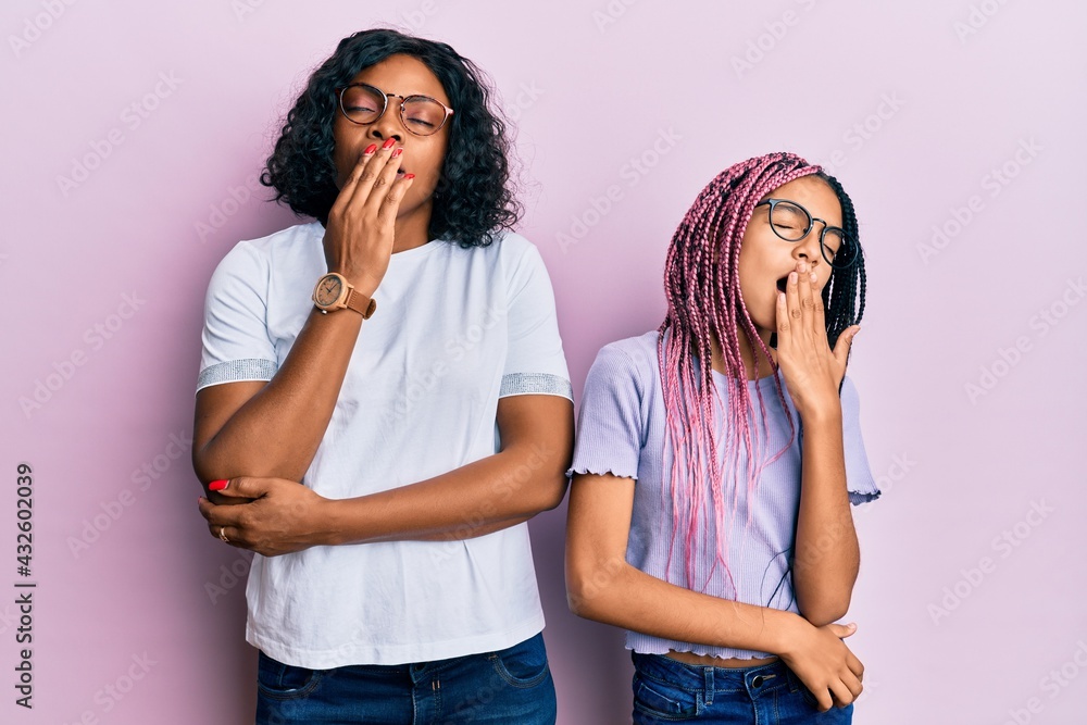 Poster beautiful african american mother and daughter wearing casual clothes and glasses bored yawning tire