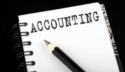 ACCOUNTING written text in small notebook on a black background